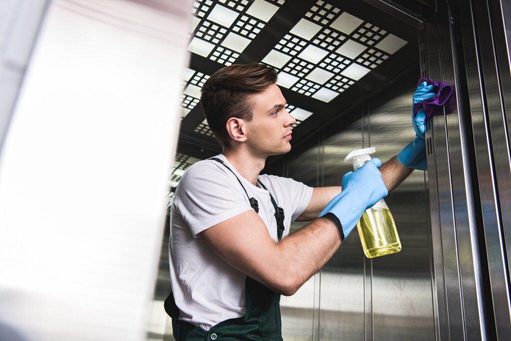 young man cleaning the elevator