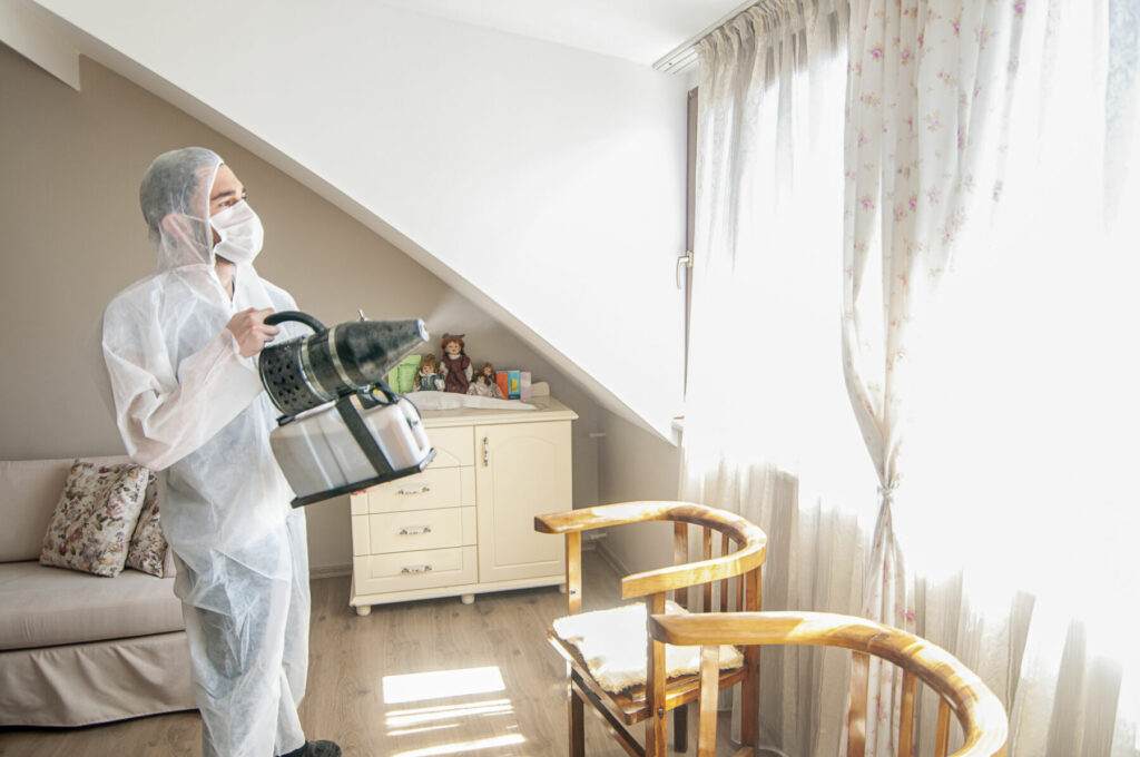 Man wearing protective biological suit and gas-mask due to mers coronavirus global pandemic warning and danger