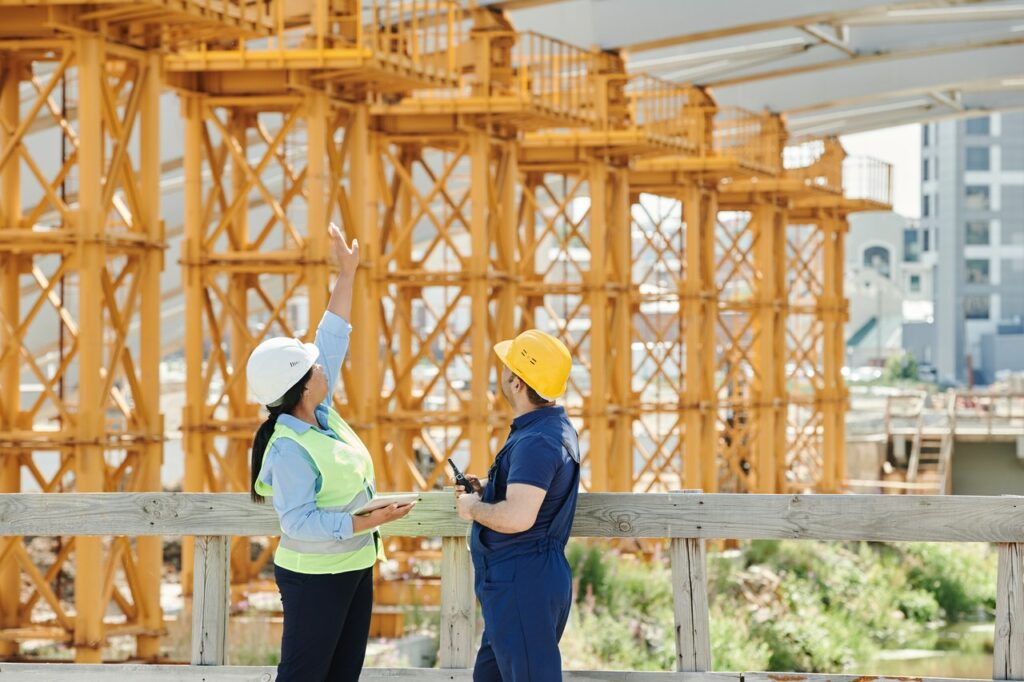 man and woman outside construction site