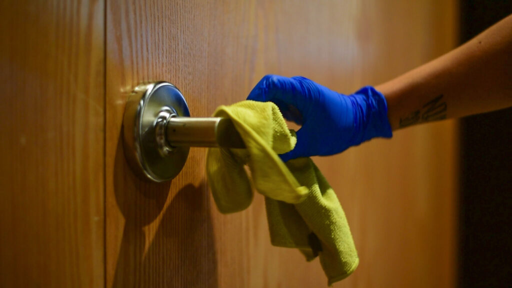 Cleaning the doorknobs