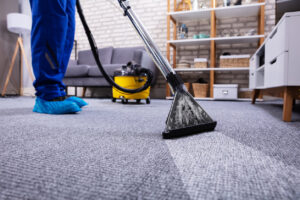 A professional cleaner cleaning and mopping a commercial carpet