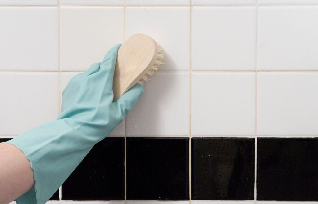 Image showing how to clean a shower by scrubbing its bathroom tiles