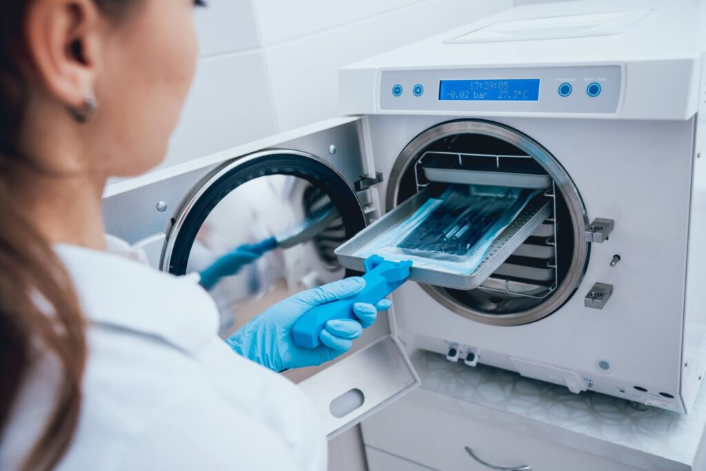 Autoclave used in sterilizing medical equipment with steam under pressure, emphasizing heat's role in disinfection.