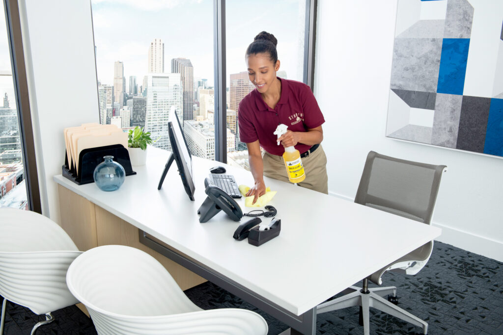 female cleaner wiping office table