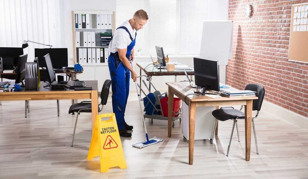 A professional commercial cleaner doing his job cleaning an office space