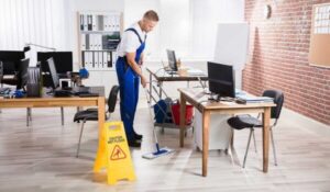 young man cleaning the office