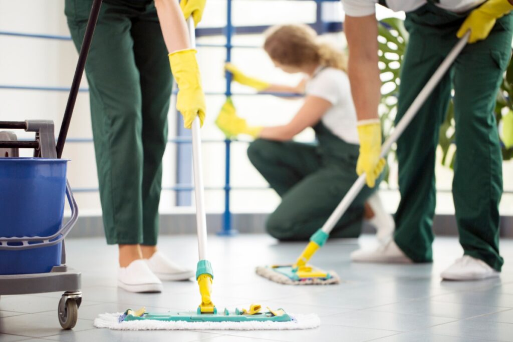 young cleaners mopping the office floor