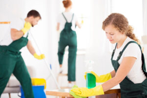 A group of professional cleaners doing professional cleaning service, relevant to reasons for hiring a cleaning professional.