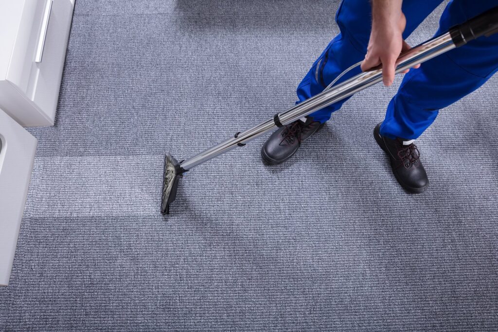 A professional cleaner doing a carpet cleaning in commercial space, relevant to ultimate cleaning checklist