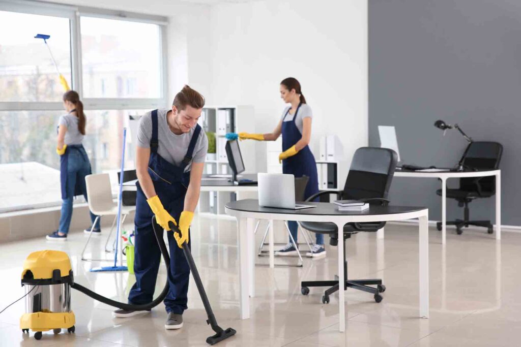 Professional cleaners at work, illustrating office cleaning cost calculator tips.