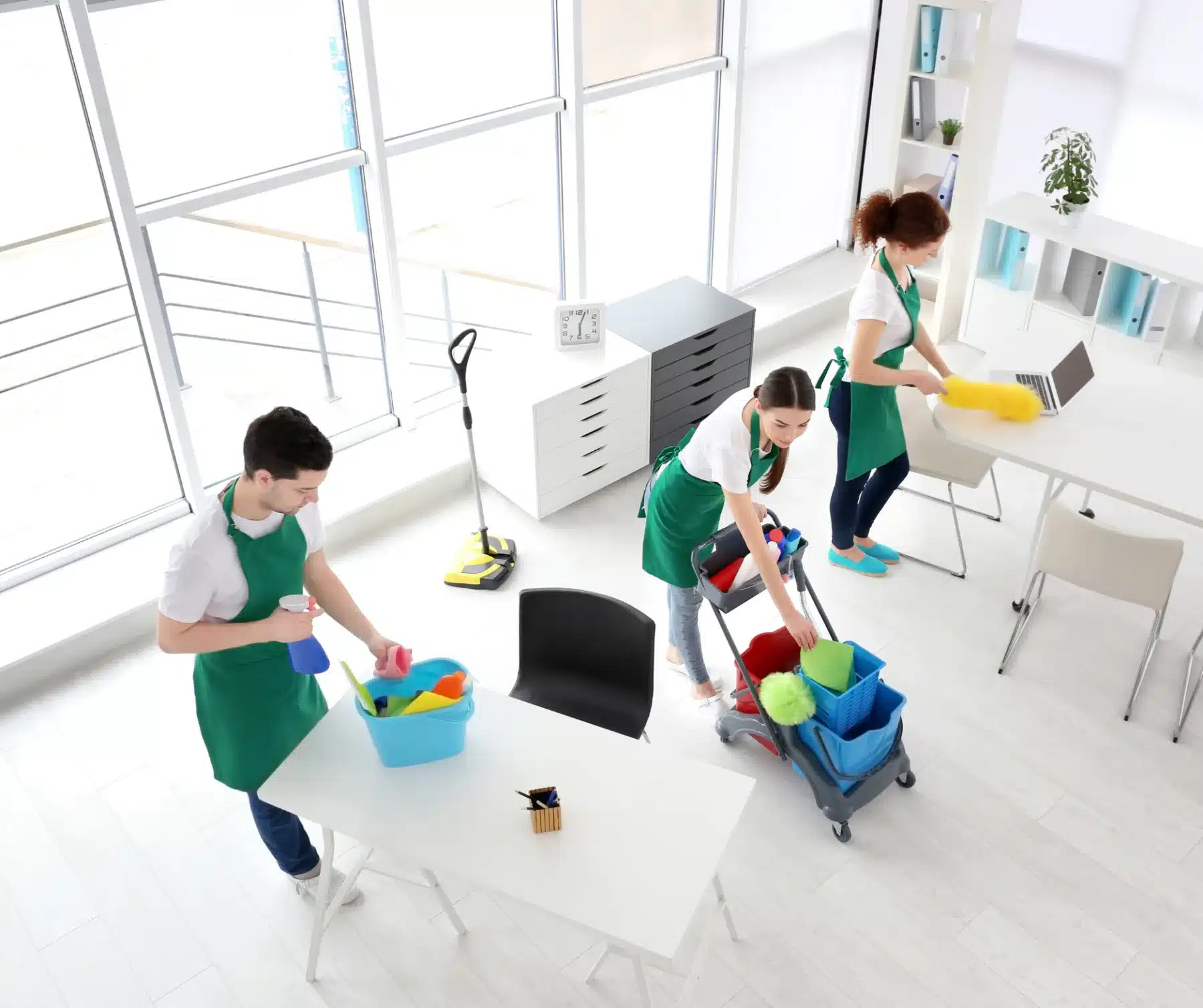 Three people cleaning in a office room