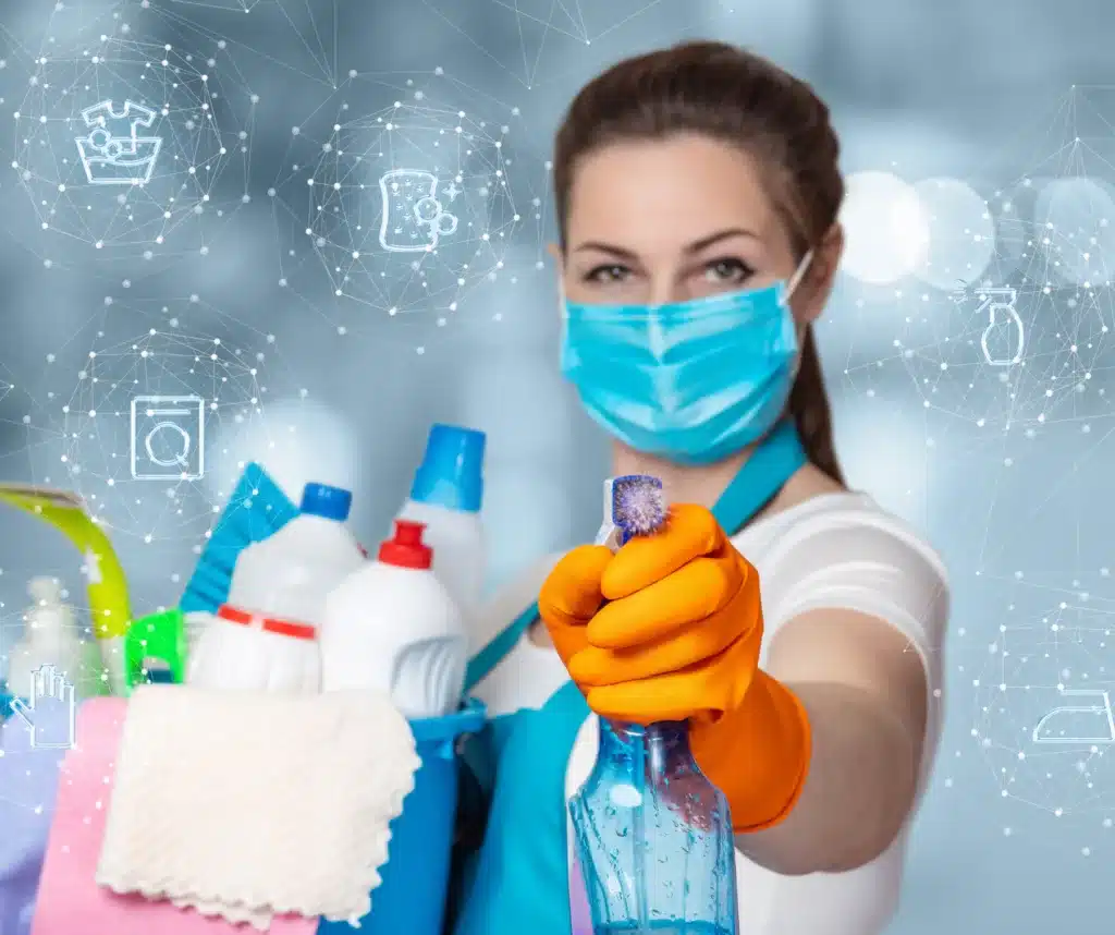 lady holding spray and cleaning supplies