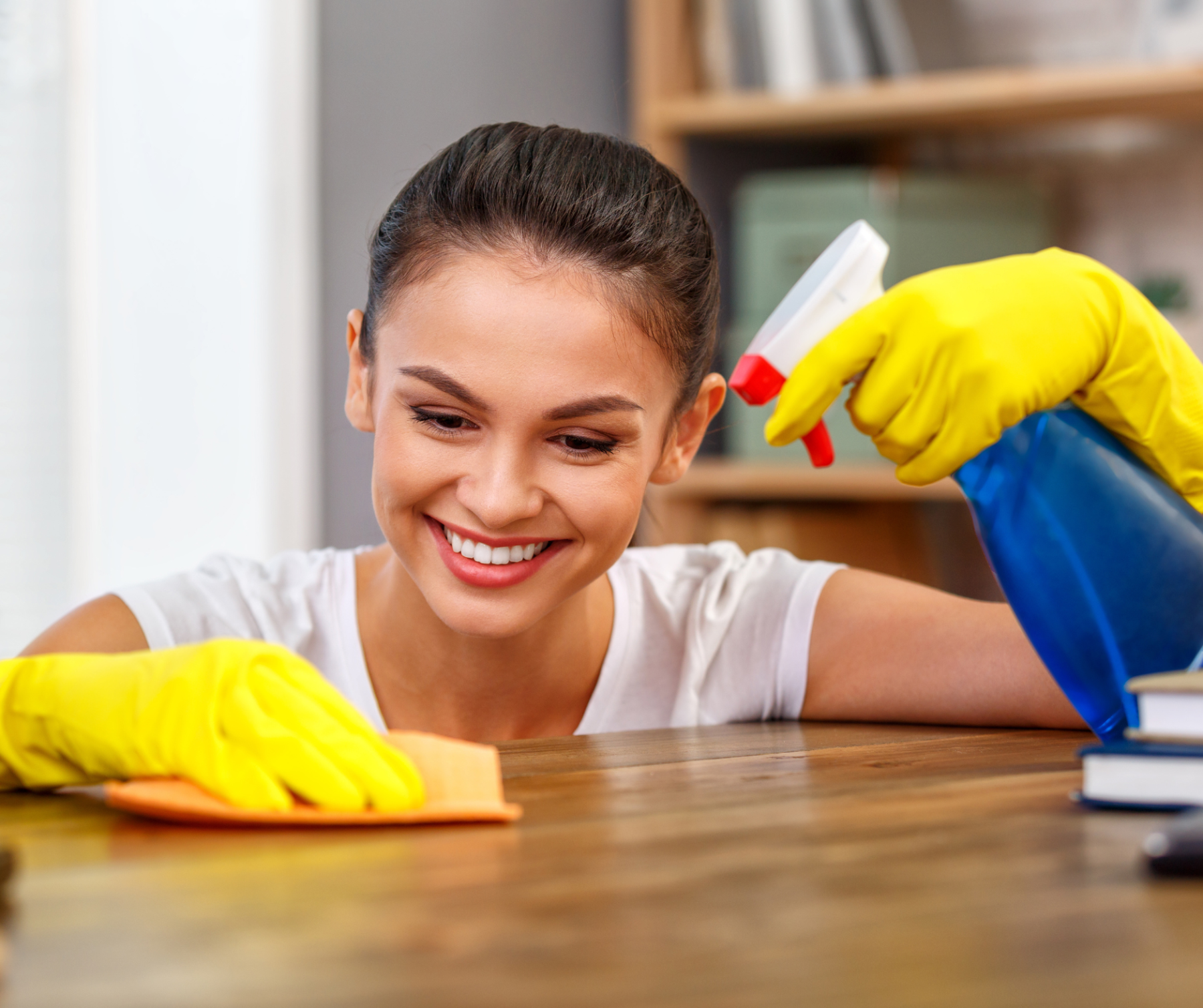 A lady cleaning meticulously the table