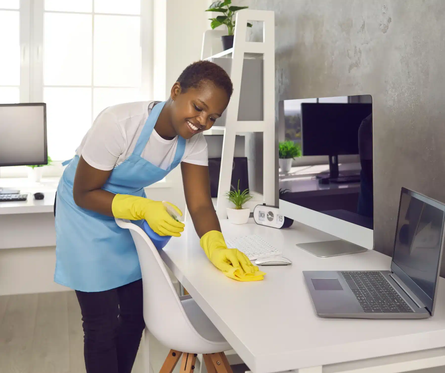 A woman cleaning office table