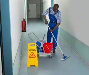 A man mopping floor in an aisle