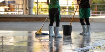 Two women mopping the ground floor