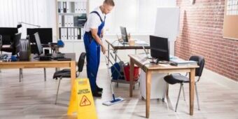 young man cleaning the office