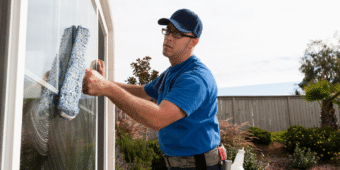 Dallas janitorial service cleaner polishing the windows