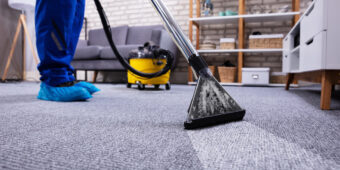 Human Cleaning Carpet In The Living Room Using Vacuum Cleaner At Home