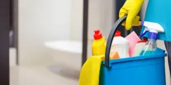 a bucket of cleaning supplies and tools