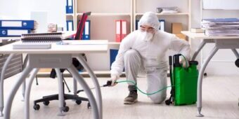 office-disinfection-service-malaysia-recommendmy-e1619521961173 man disinfecting under the office table